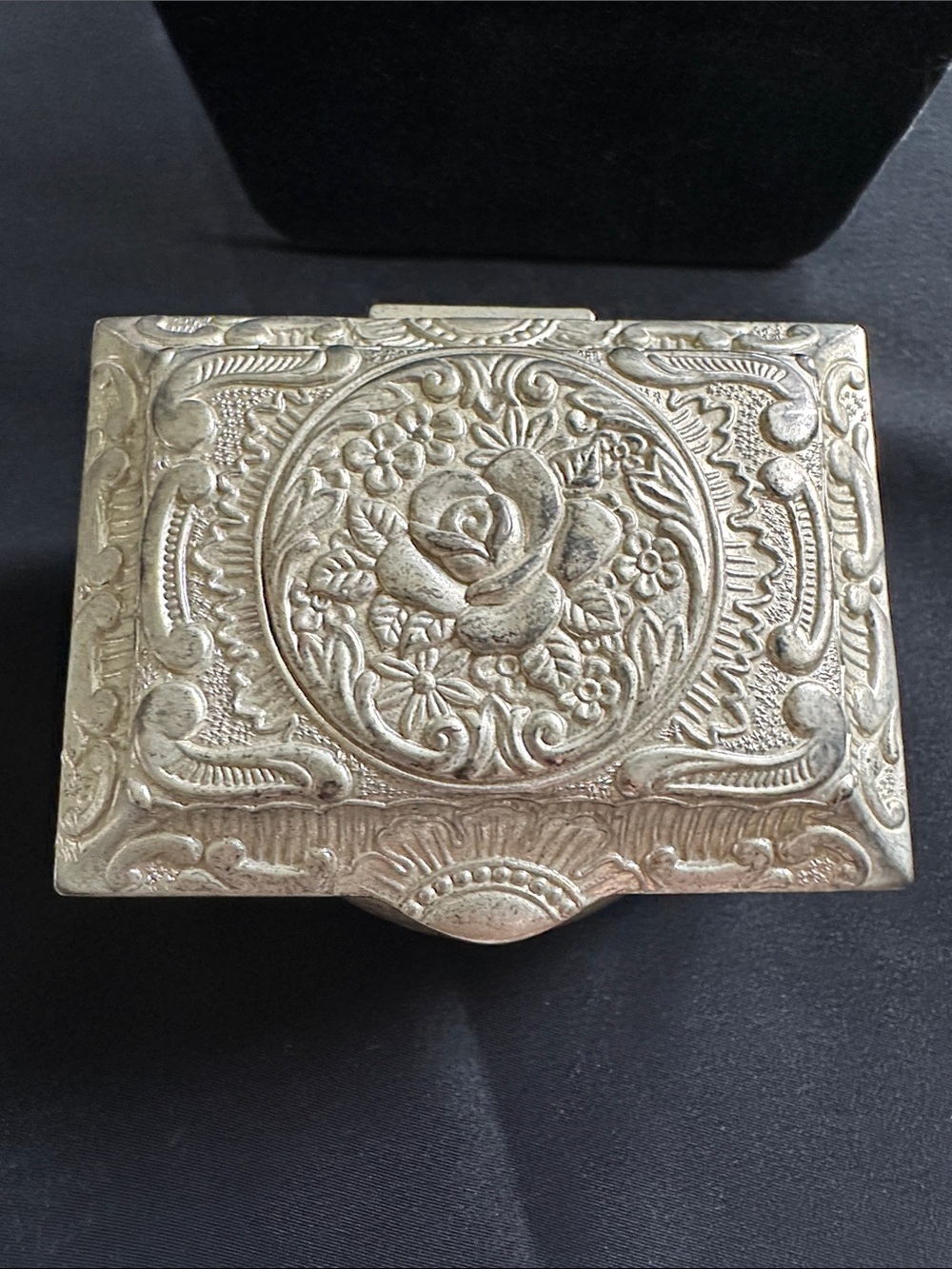 Vintage silvertone EUC metal trinket box. Rose designed lid w/ red velvet lining